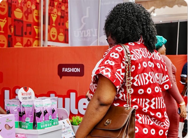 A visitor shopping at a local business stand