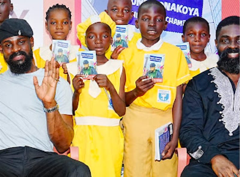 Pupils displaying books at a Leadway reading event