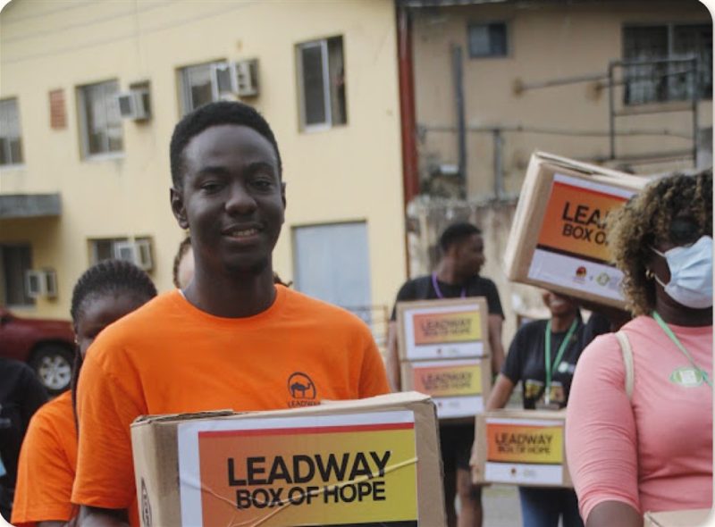 A volunteer holding a Leadway Box of Hope